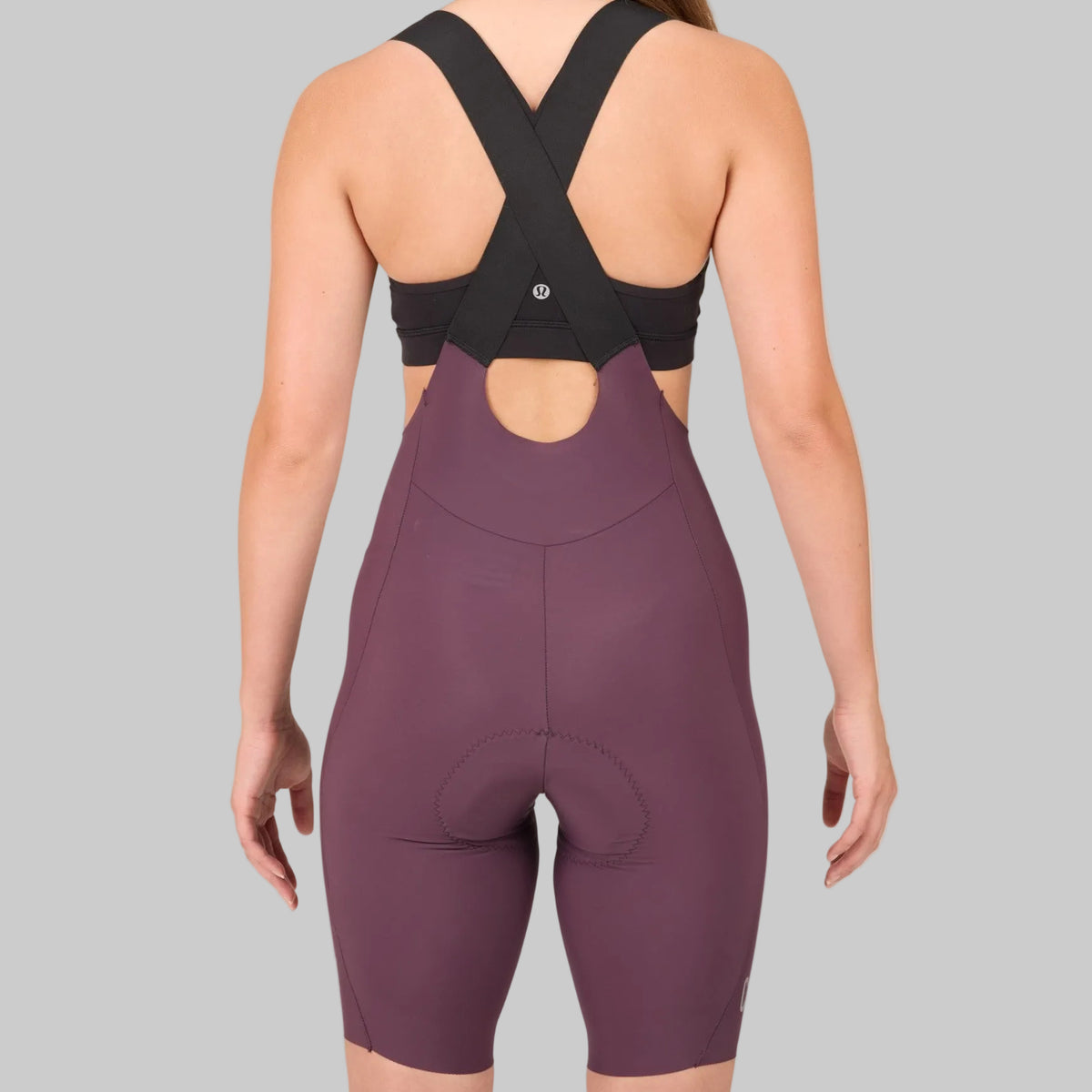 Capo women's drop tail bib shorts in burgundy, rear view