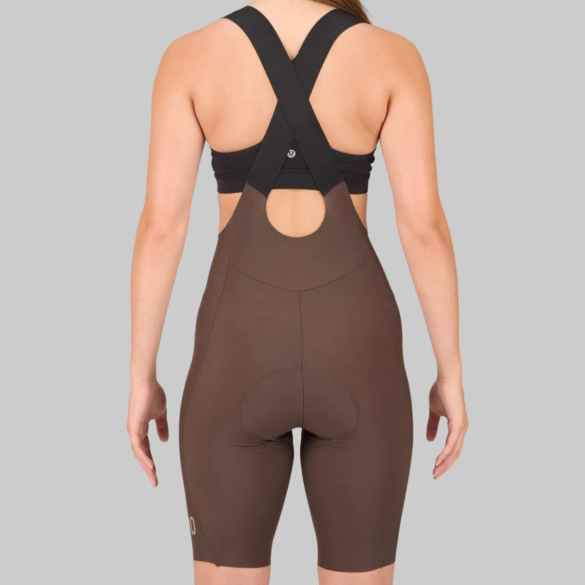 Capo women's drop tail bib shorts in chocolate brown, rear view